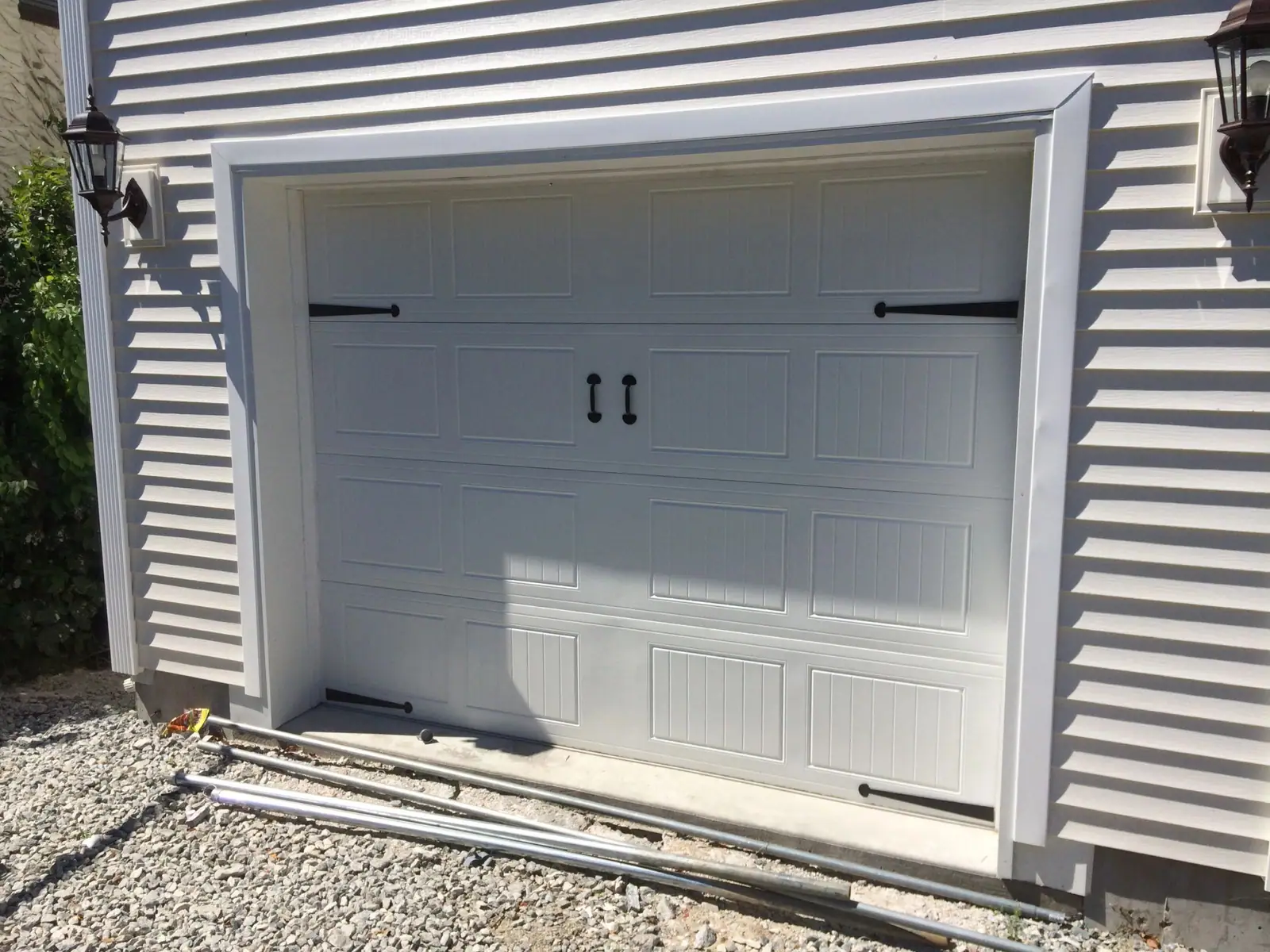 A white carriage-house door on a Scarsdale Tudor