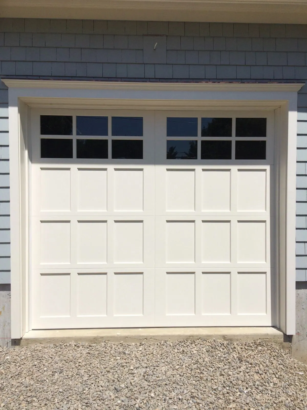 A carriage-style garage door on a New Rochelle colonial