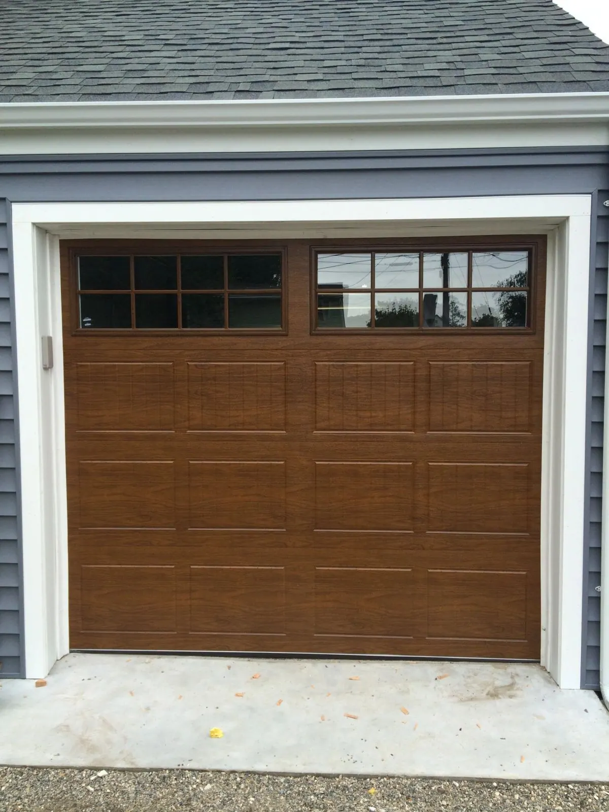 A wood-look carriage door on an older Mamaroneck harbor home
